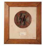 A FRAME CONTAINING AN SS SYMBOL AND SIGNATURE WITH EAGLE STAMP.