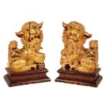 A PAIR OF 20TH CENTURY CHINESE GILTWOOD DOGS OF FO