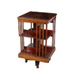 AN EDWARDIAN MAHOGANY AND MARQUETRY REVOLVING BOOKCASE