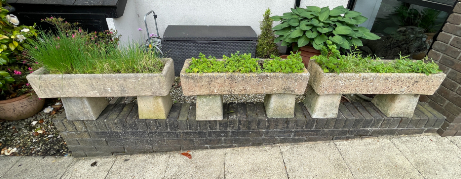 A GROUP OF THREE STONE PLANTERS