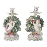 A PAIR OF DERBY PORCELAIN CANDLESTICKS MODELLED AS CUPIDS