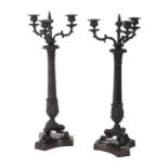 A PAIR OF REGENCY STYLE BRONZE PATINATED THREE BRANCH CANDLEABRA