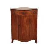 A REGENCY MAHOGANY BOWFRONT CORNER WASHSTAND