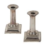 A PAIR OF SILVER CANDLESTICKS