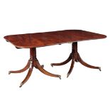 A FIGURED MAHOGANY TWO-PILLAR DINING TABLE IN GEORGE III STYLE