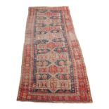 AN ANTIQUE CAUCASIAN LONG RUG