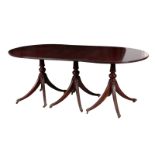 A GEORGE III STYLE MAHOGANY THREE-PILLAR DINING TABLE