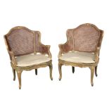 A PAIR OF LOUIS XV STYLE POLYCHROME AND PARCEL-GILT BERGERE ARMCHAIRS