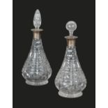 A PAIR OF CUT GLASS AND SILVER COLLARED DECANTERS