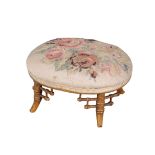 A VICTORIAN GILTWOOD OVAL FOOTSTOOL