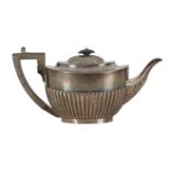 AN EDWARDIAN SILVER TEAPOT BY MARTIN, HALL & CO.