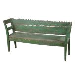A CONTINENTAL GREEN-PAINTED AND DISTRESSED HALL BENCH