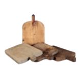 A GROUP OF FOUR RUSTIC BREAD OR CHOPPING BOARDS