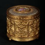 A FRENCH EMBOSSED BRASS CYLINDRICAL MUSICAL JEWELLERY BOX