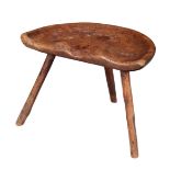 A PRIMITIVE ELM DAIRY STOOL