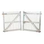 A PAIR OF GREEN-PAINTED OAK AND CAST IRON GATES