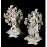 A PAIR OF 18TH CENTURY DUESBURY & CO DERBY PORCELAIN CANDLESTICKS - MUSICAL SHEPHERD & SHEPHERDESS