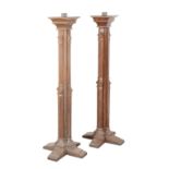 A PAIR OF VICTORIAN PARCEL GILT OAK TORCHERES OF ECCLESIASTICAL DESIGN