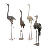 A GROUP OF FOUR PAINTED METAL STORKS