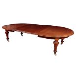 A VICTORAN MAHOGANY OVAL EXTENDING DINING TABLE