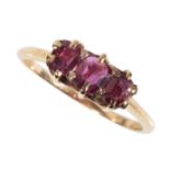 A THREE STONE RUBY DRESS RING