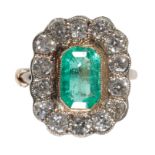 AN EMERALD AND DIAMOND CLUSTER RING