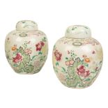 A PAIR OF CHINESE FAMILLE ROSE JARS AND COVERS