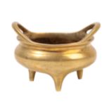 A CHINESE GILT BRONZE MINIATURE TRIPOD CENSER