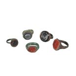 A COLLECTION OF FIVE ROMAN STYLE BRONZE RINGS