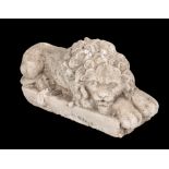 A COMPOSITE STONE MODEL OF A RECUMBENT LION