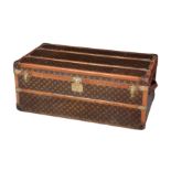 A LOUIS VUITTON STAMPED LEATHER BRASS-BOUND WOODEN TRUNK