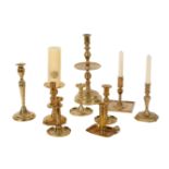 A COLLECTION OF TEN BRASS CANDLESTICKS