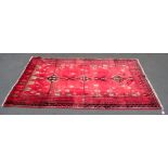 A RED GROUND AND CREAM GONBAD RUG
