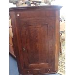 A GEORGE III OAK HANGING CORNER CUPBOARD