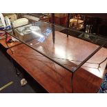 A METAL FRAMED COFFEE TABLE WITH GLASS TOP
