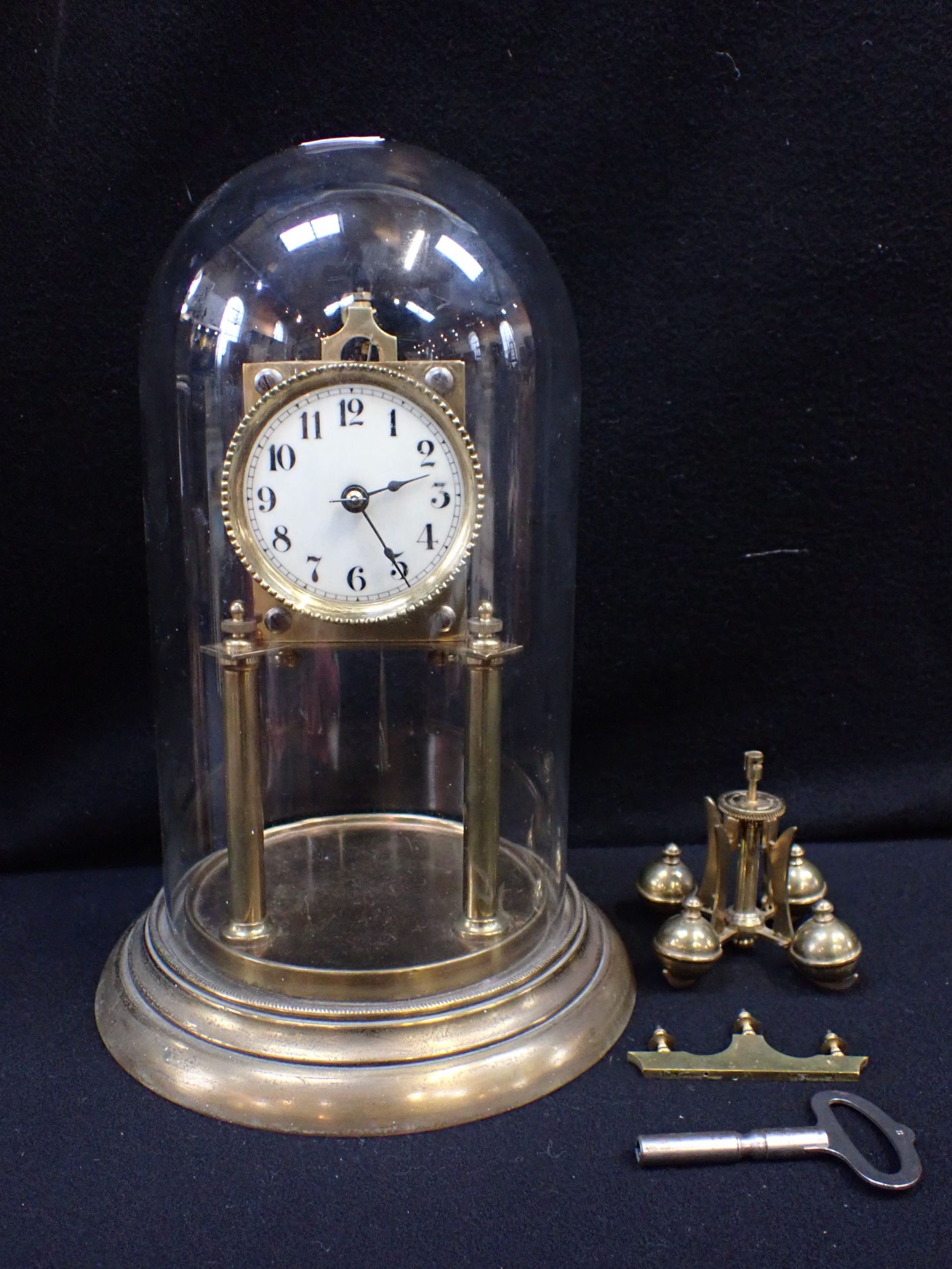 AN ANNIVERSARY CLOCK IN A GLASS DOME