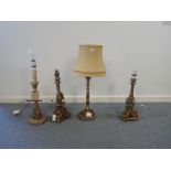 A GROUP OF FOUR CARVED GILTWOOD AND COMPOSITION LAMP BASES