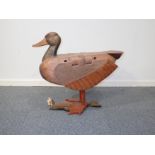A LARGE CARVED WOODEN DUCK