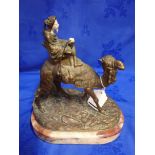 A BRONZE AND IVORY FIGURE OF A MIDDLE EASTERN MAN RIDING ON A CAMEL
