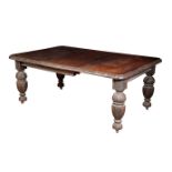 A VICTORIAN OAK EXTENDING DINING TABLE