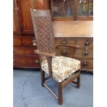 AN ARTS AND CRAFTS STYLE OAK ARMCHAIR