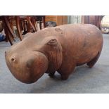 A CARVED WOODEN HIPPOPOTAMUS