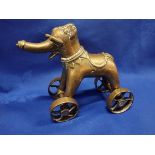 A CAST BRASS ELEPHANT ON WHEELS, POSSIBLY BURMESE