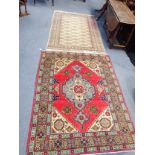 A RED PERIAN RUG WITH A 'GOLD' AFGHAN RUG