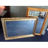A DECORATIVE GILT FRAMED WALL MIRROR, WITH BEVELLED PLATE