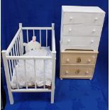 A WOODEN DOLL'S COT WITH TWO MINATURE CHESTS OF DRAWERS