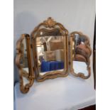 A GILT-FRAMED DRESSING TABLE MIRROR