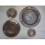 A PEWTER PLATE, AND THREE SMALLER, THE SMALLEST WITH TURNED RIM