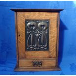 AN EDWARDIAN ART NOUVEAU OAK SMOKER'S CABINET