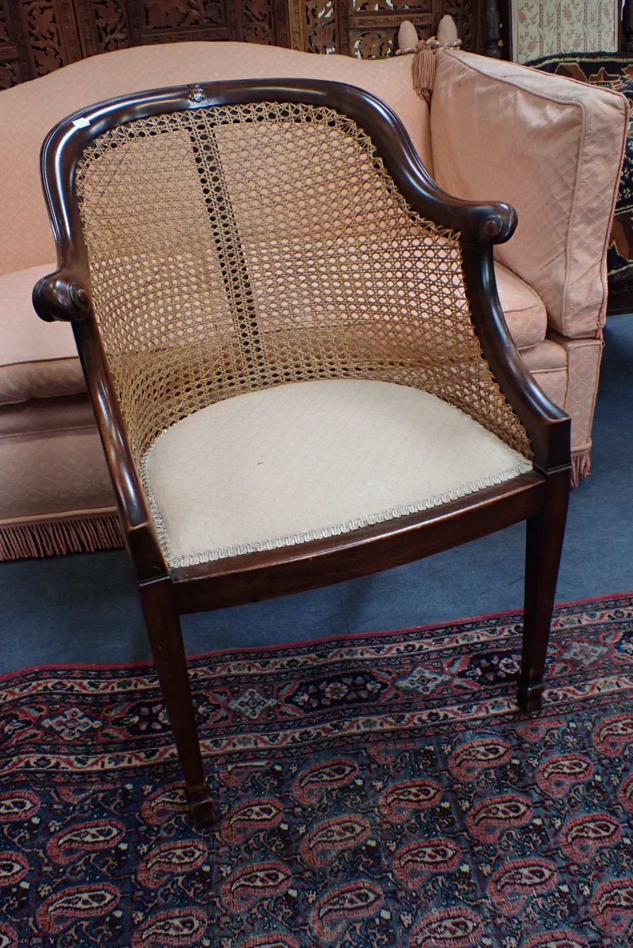 A MAHOGANY AND CANED BERGERE CHAIR